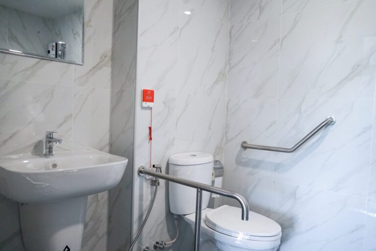 Private bathroom with handrails and call button